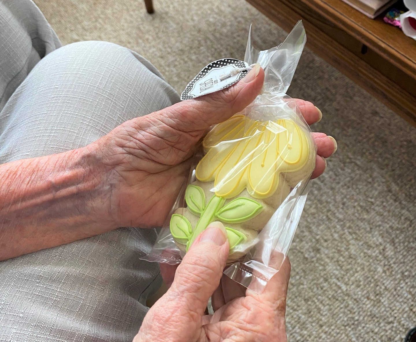 a resident holding a beautiful homemade cookie she received on Mother's Day 