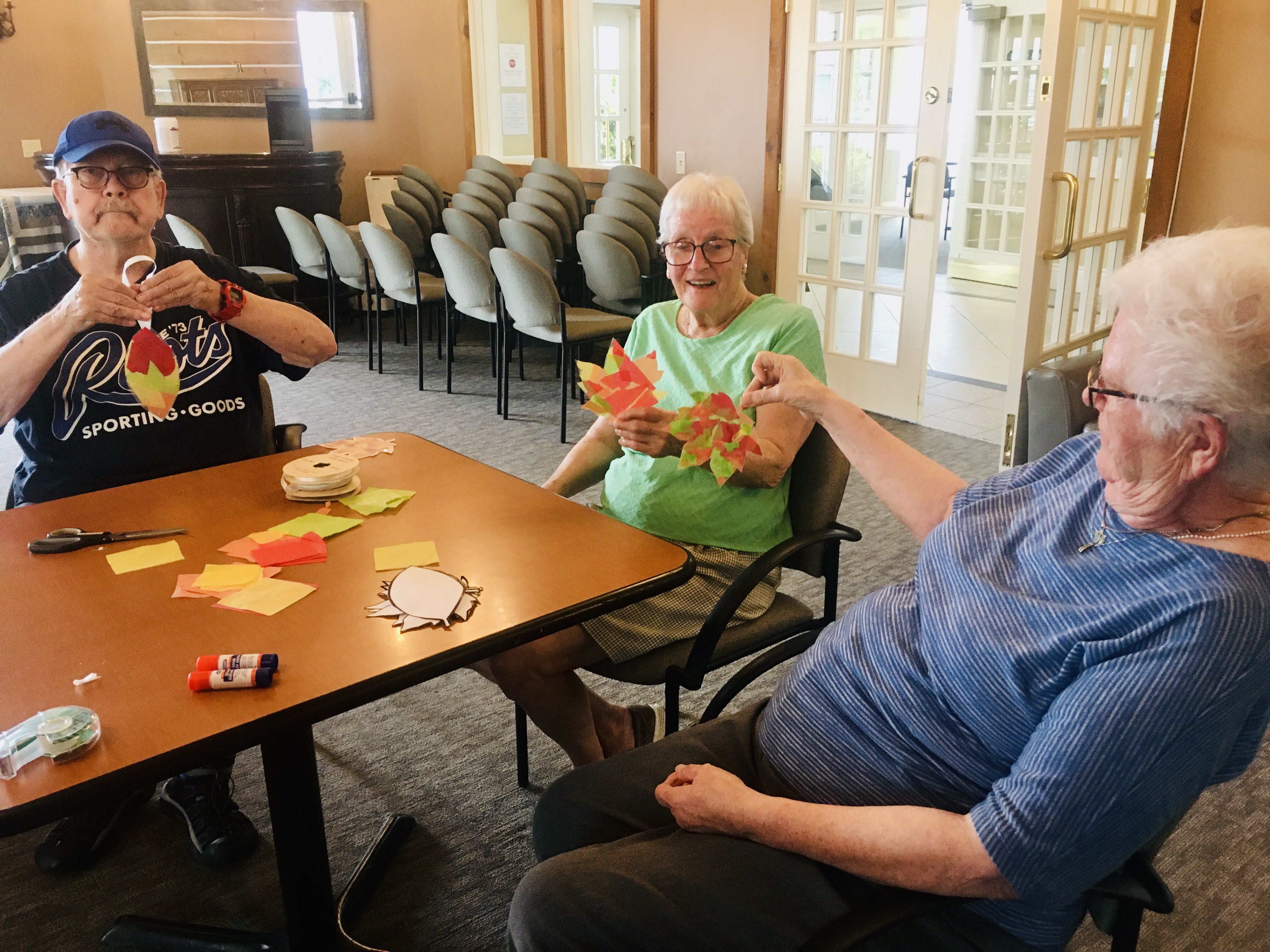 Image of residents making and holding autumn crafts at Luther Village on the Park.