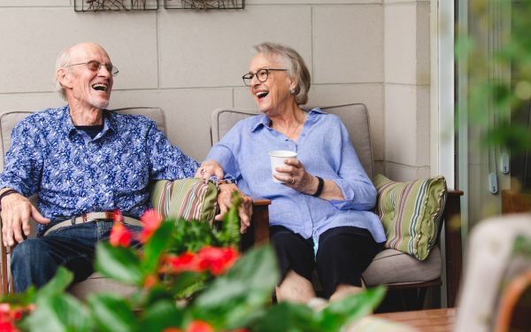 Two residents enjoy coffee at Luther village on the park