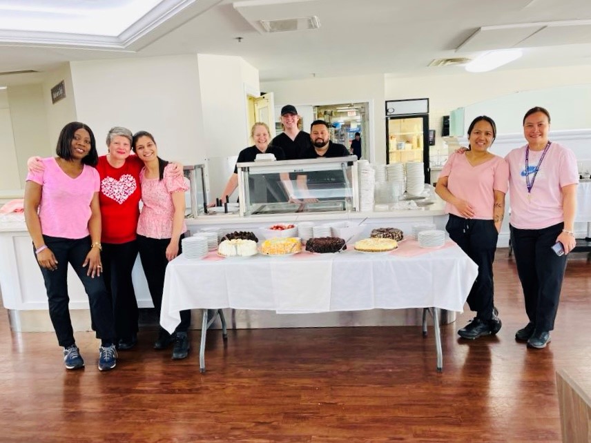 Staff and resident pose for photo at Mother's Day celebrations at Luther Village on the Park