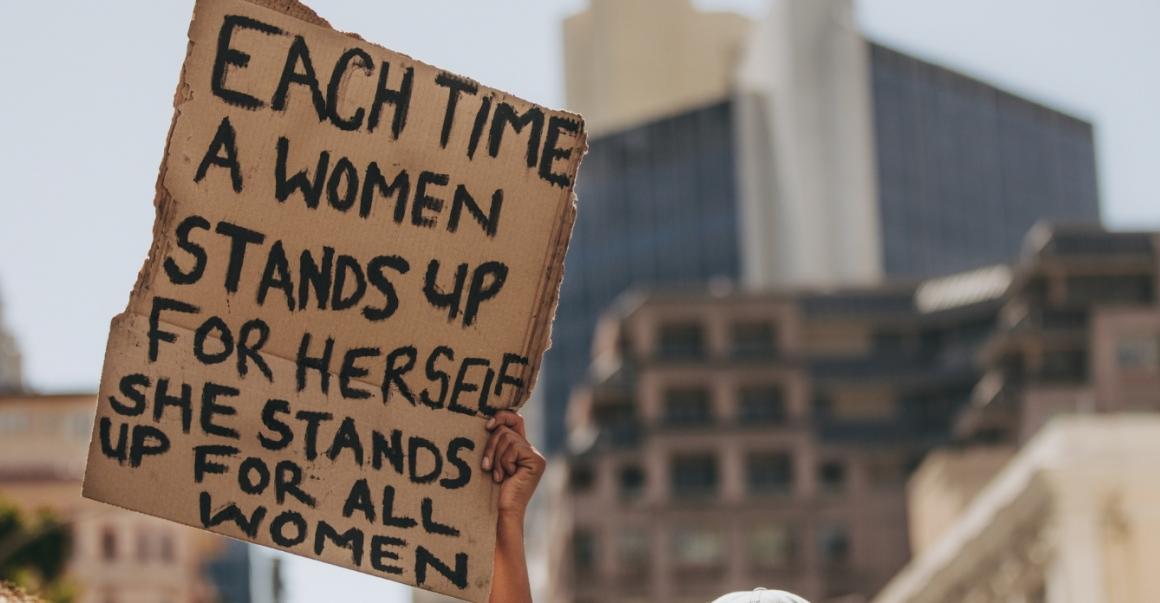 a poster that reads "each time a women stands up for herself she stands up for all women"