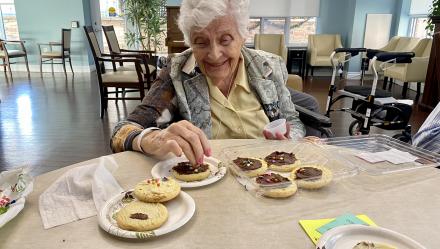 Image of resident decorating cookies at Luther Village on the Park.