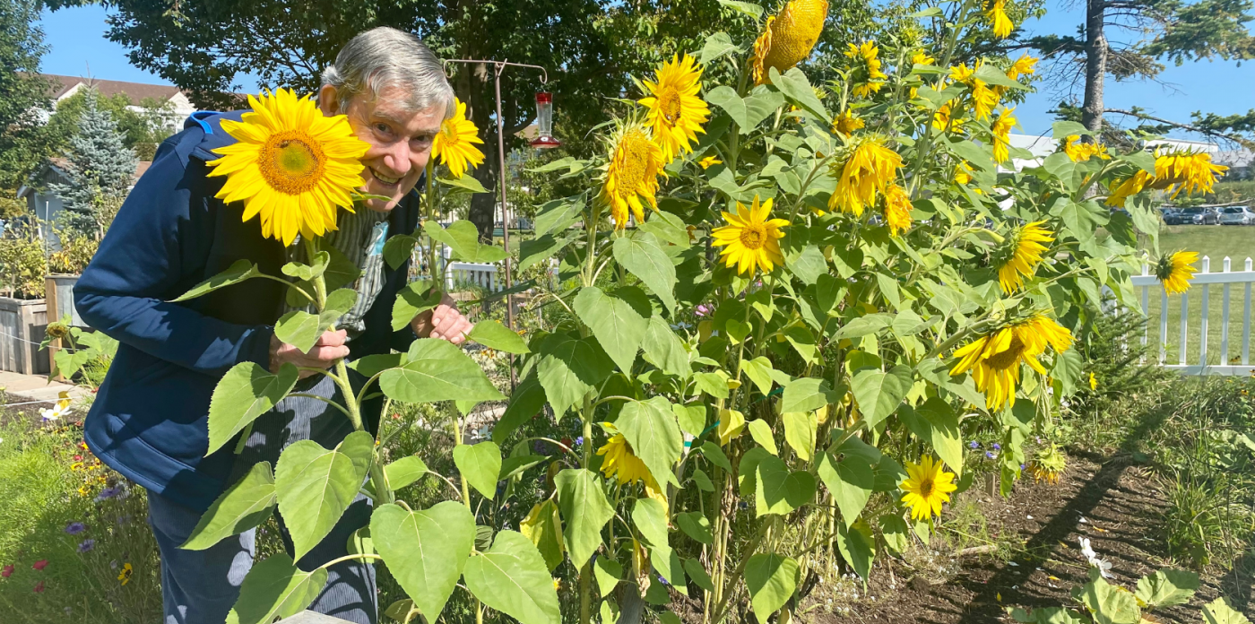 Resident with sunflowers at Luther Village on the Park